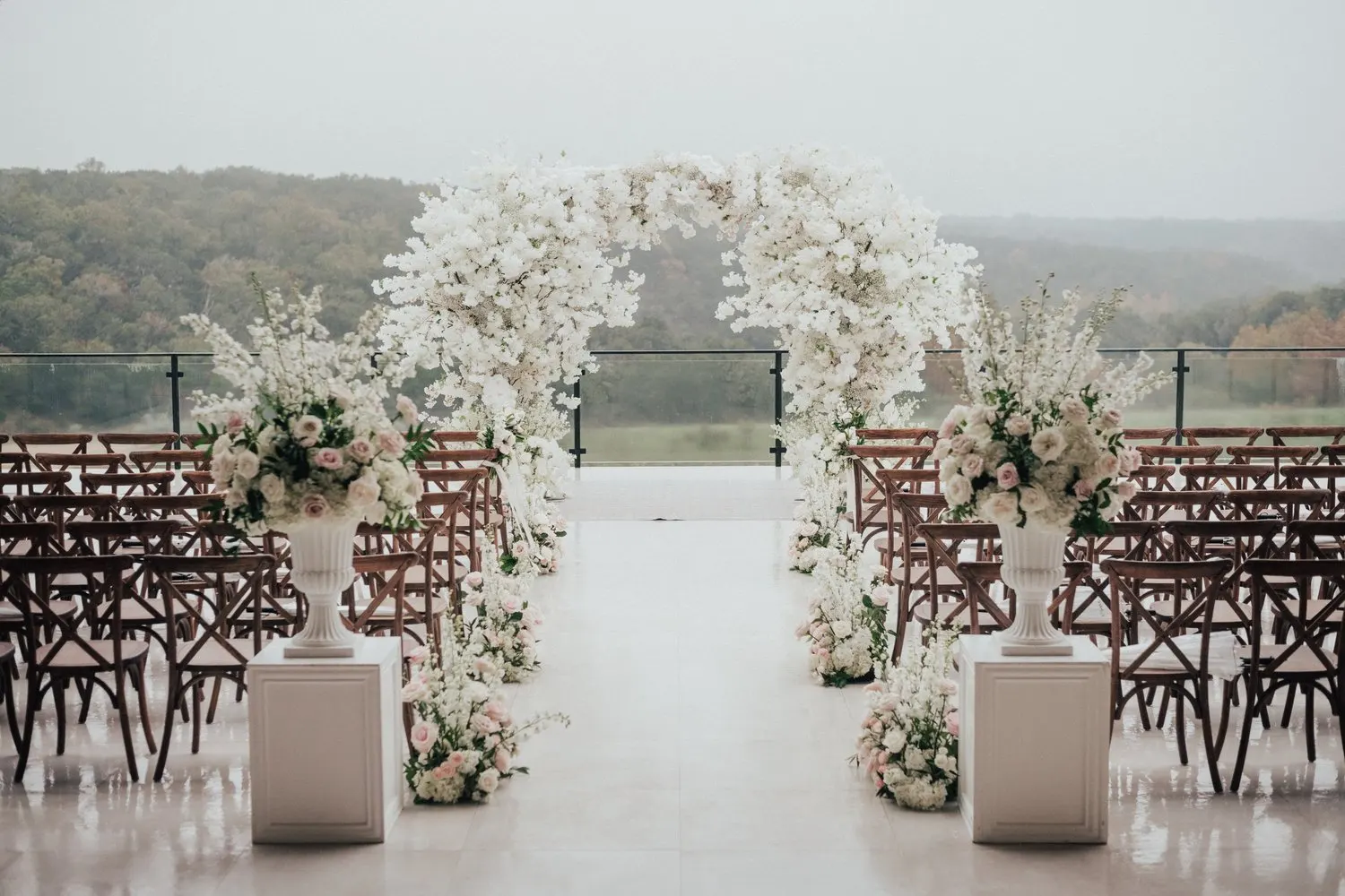 Ivory floral ceremony arch overlooking the Texas Hill Country at The Videre Estate